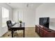 Well-lit office space featuring a large desk, TV, and comfortable seating at 977 Capricorn Dr, Franklin, IN 46131