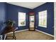 Office space featuring blue walls, carpeted floors, and two bright windows at 977 Capricorn Dr, Franklin, IN 46131