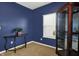 Office space with blue walls, carpeted floors, display case, and a bright window at 977 Capricorn Dr, Franklin, IN 46131