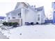 Charming white house with wood accents, covered porch, and snow-covered yard at 1022 Villa Ave, Indianapolis, IN 46203