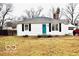 Cute ranch home with teal door, landscaping, and detached garage at 120 Hoss Rd, Indianapolis, IN 46217