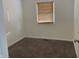 Small bedroom with window and neutral walls at 1360 S Cherry St, Martinsville, IN 46151