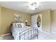 Bedroom with ceiling fan, bedside table, closet with mirror and window with curtains at 14832 Sulky Way, Carmel, IN 46032