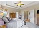 Comfortable main bedroom with tray ceilings, closet, and ensuite bathroom at 14832 Sulky Way, Carmel, IN 46032