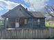 A rustic wood house with boarded windows, needing repairs at 1520 N Bancroft St, Indianapolis, IN 46201