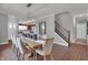 Sunlit dining room adjacent to kitchen and staircase, with hardwood floors at 166 Cline St, Westfield, IN 46074