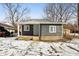 Gray house with white trim, covered porch, and small yard in the winter at 1821 N Dequincy St, Indianapolis, IN 46218