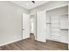 Bright bedroom with wood-look flooring and a large closet at 201 S Mckinley St, North Salem, IN 46165