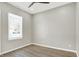 Simple bedroom with wood-look flooring and a window at 201 S Mckinley St, North Salem, IN 46165