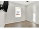 Cozy bedroom with a large window and hardwood floors at 201 S Mckinley St, North Salem, IN 46165