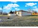 Exterior view of the home featuring manicured lawn and gray brick exterior at 201 S Mckinley St, North Salem, IN 46165
