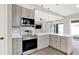 Modern kitchen with stainless steel appliances and white countertops at 201 S Mckinley St, North Salem, IN 46165