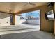 View of spacious covered patio with a ceiling fan, a television, and outside access at 201 S Mckinley St, North Salem, IN 46165