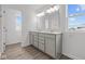 Bathroom showcasing a double vanity with modern fixtures and wood-look flooring at 2310 Marjorie Way, Shelbyville, IN 46176