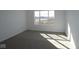 Bedroom featuring neutral carpeting, white walls and a large window providing natural light at 2310 Marjorie Way, Shelbyville, IN 46176