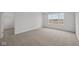 Inviting bedroom with neutral carpeting, a large window offering natural light, and a walk-in closet at 2310 Marjorie Way, Shelbyville, IN 46176