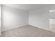 Bare bedroom featuring soft, neutral carpeting, bright lighting, and easy access to other rooms at 2310 Marjorie Way, Shelbyville, IN 46176