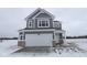 Charming two-story home with gray siding and a large two-car garage with a snow-covered lawn at 2310 Marjorie Way, Shelbyville, IN 46176