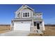 Charming two-story home with gray siding, white trim, and a spacious two-car garage at 2310 Marjorie Way, Shelbyville, IN 46176