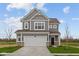 Charming two-story home with gray siding, white trim, two-car garage, and landscaped yard at 2310 Marjorie Way, Shelbyville, IN 46176