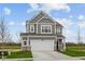 Charming two-story home with gray siding, white trim, two-car garage, and landscaped yard at 2310 Marjorie Way, Shelbyville, IN 46176