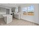 Spacious kitchen featuring an island, stainless steel appliances, gray cabinets, and luxury vinyl plank flooring at 2310 Marjorie Way, Shelbyville, IN 46176