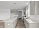 Open-concept kitchen with gray cabinets, a large island, stainless steel appliances, and luxury vinyl plank flooring at 2310 Marjorie Way, Shelbyville, IN 46176