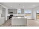 Bright kitchen featuring stainless steel appliances, gray cabinets, an island, and luxury vinyl plank flooring at 2310 Marjorie Way, Shelbyville, IN 46176
