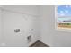 Laundry room with utility hookups, shelving and a window offering natural light at 2310 Marjorie Way, Shelbyville, IN 46176
