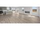 Spacious living room featuring hardwood floors, a modern fireplace, and an open layout with kitchen views at 2310 Marjorie Way, Shelbyville, IN 46176