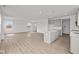 Open living space showcasing luxury vinyl plank flooring, and an adjacent kitchen at 2310 Marjorie Way, Shelbyville, IN 46176