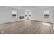 Open living space showcasing luxury vinyl plank flooring, fireplace and bright natural light at 2310 Marjorie Way, Shelbyville, IN 46176