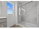 Modern bathroom with a glass enclosed shower and marble tile surround at 2310 Marjorie Way, Shelbyville, IN 46176
