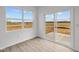 Bright sunroom with large windows and sliding glass doors offering scenic outdoor views and access to the patio at 2310 Marjorie Way, Shelbyville, IN 46176