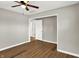 Bedroom with wood-look floors, ceiling fan and access to another room at 2319 N Rural St, Indianapolis, IN 46218