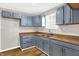 Gray kitchen cabinets, brown countertops, and vinyl flooring at 2319 N Rural St, Indianapolis, IN 46218