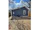 Exterior rear view with gray siding, new windows and gravel landscaping at 2320 Spann Ave, Indianapolis, IN 46203