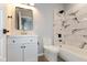 Bathroom featuring a white vanity, soaking tub, and marble tile shower at 2320 Spann Ave, Indianapolis, IN 46203