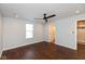 Bright bedroom with ceiling fan, ensuite bathroom access, and dark hardwood floors at 2320 Spann Ave, Indianapolis, IN 46203