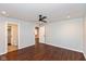 Bedroom with ceiling fan, hardwood floors, and ensuite bathroom at 2320 Spann Ave, Indianapolis, IN 46203
