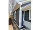 Side view of house with dark gray siding, white trim, new windows and landscaping at 2320 Spann Ave, Indianapolis, IN 46203
