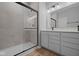 Modern bathroom featuring a tiled shower with sliding glass door and a double sink vanity at 3617 Wrangler Dr, Bargersville, IN 46106