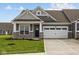 Charming home featuring a two-car garage, stone accents, and well-manicured lawn at 3617 Wrangler Dr, Bargersville, IN 46106