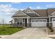 Charming home featuring a two-car garage, stone accents, and well-manicured lawn at 3617 Wrangler Dr, Bargersville, IN 46106