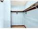 Functional walk-in closet provides easy storage with ample shelving and rod space, and durable vinyl flooring at 4669 Stansbury Ln, Indianapolis, IN 46254