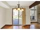 Bright dining area with hardwood floors, slider to deck, and views of living room fireplace at 4669 Stansbury Ln, Indianapolis, IN 46254