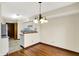 Bright dining area featuring hardwood floors and views to the kitchen at 4669 Stansbury Ln, Indianapolis, IN 46254