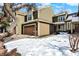 Green two-story home with snow-covered lawn and attached garage at 4669 Stansbury Ln, Indianapolis, IN 46254