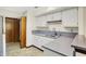 Galley-style kitchen with white cabinets and solid countertops, offering ample storage and counter space at 4669 Stansbury Ln, Indianapolis, IN 46254