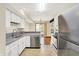 Open kitchen with stainless steel appliances and view to the living area and yard at 4669 Stansbury Ln, Indianapolis, IN 46254